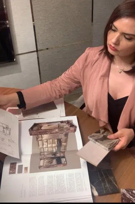 Gabriela Brum reviewing material samples for a closet design