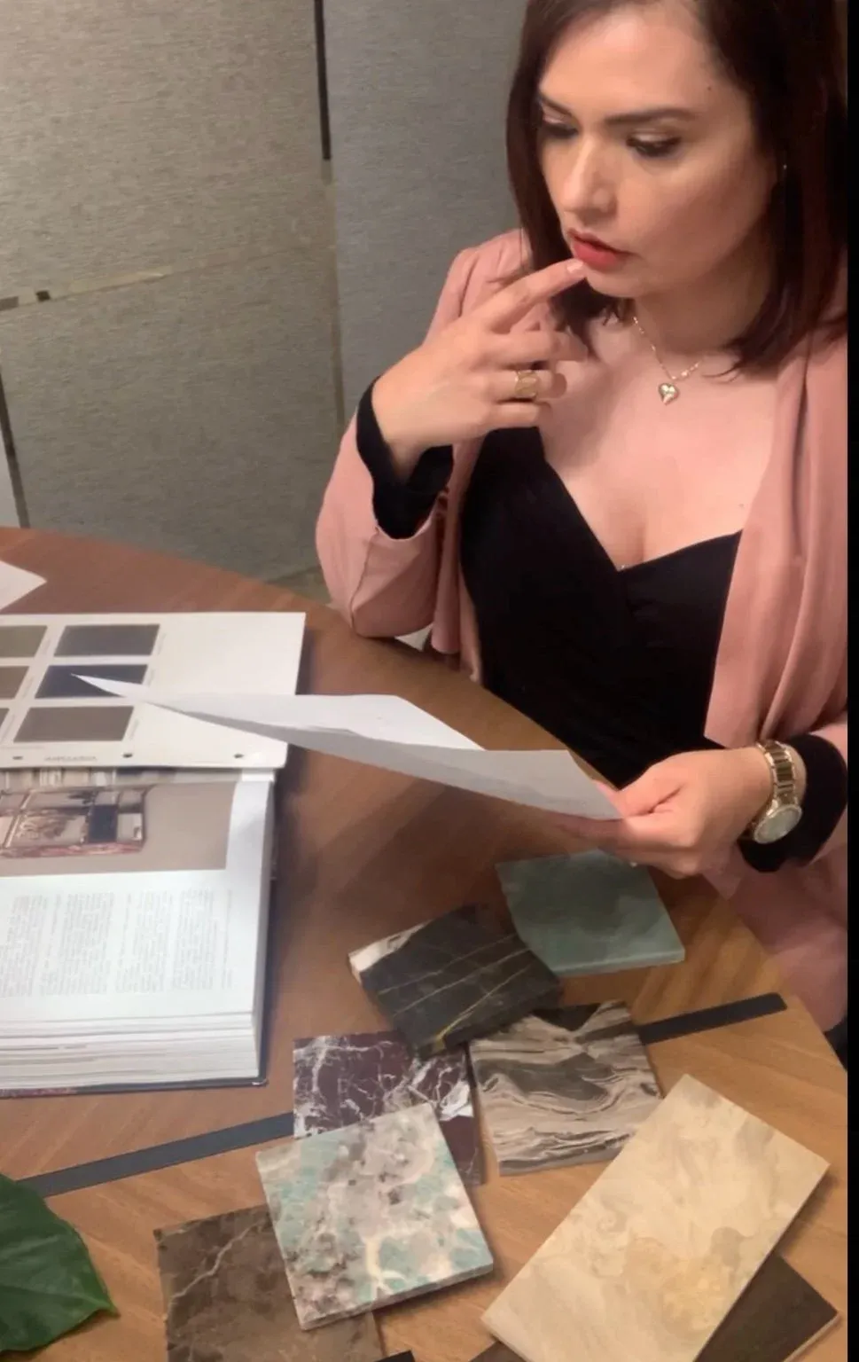 Gabriela Brum reviewing fabric and material samples